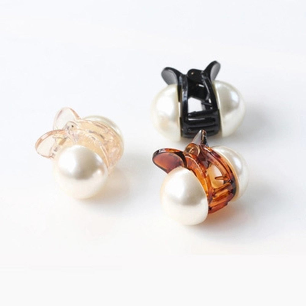 Woman styling hair with mini pearl hair claw clip in champagne color