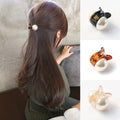 Woman styling hair with mini pearl hair claw clip in champagne color
