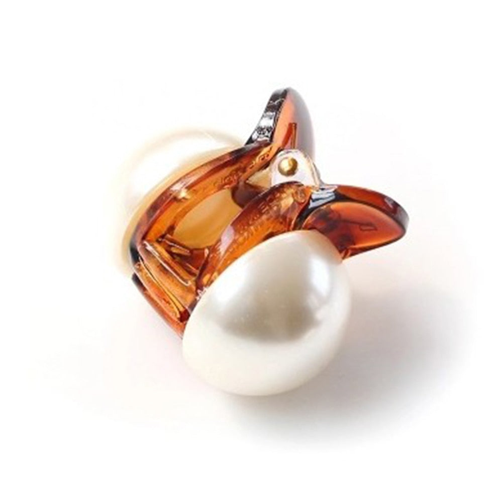Woman styling hair with mini pearl hair claw clip in champagne color