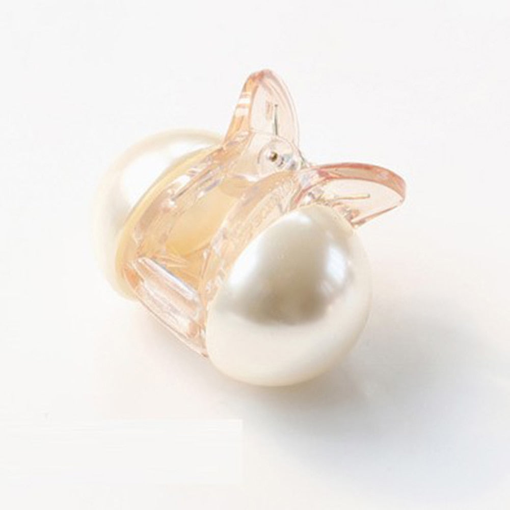 Woman styling hair with mini pearl hair claw clip in champagne color