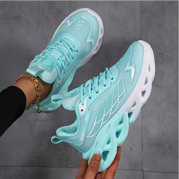Pair of light blue breathable running shoes with lace-up closure